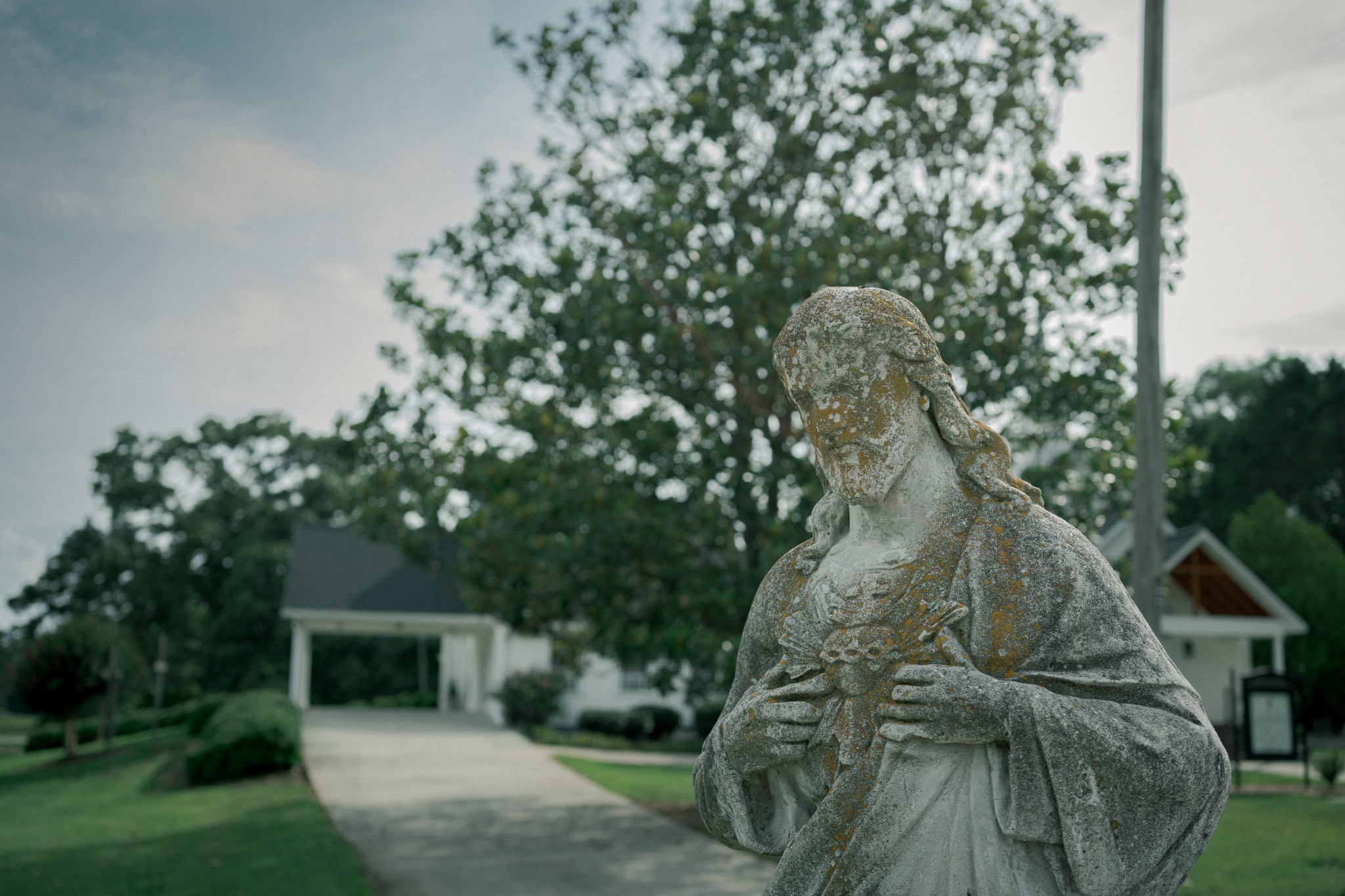 Stone statue in a quiet cemetery — photography by Andrew Frady