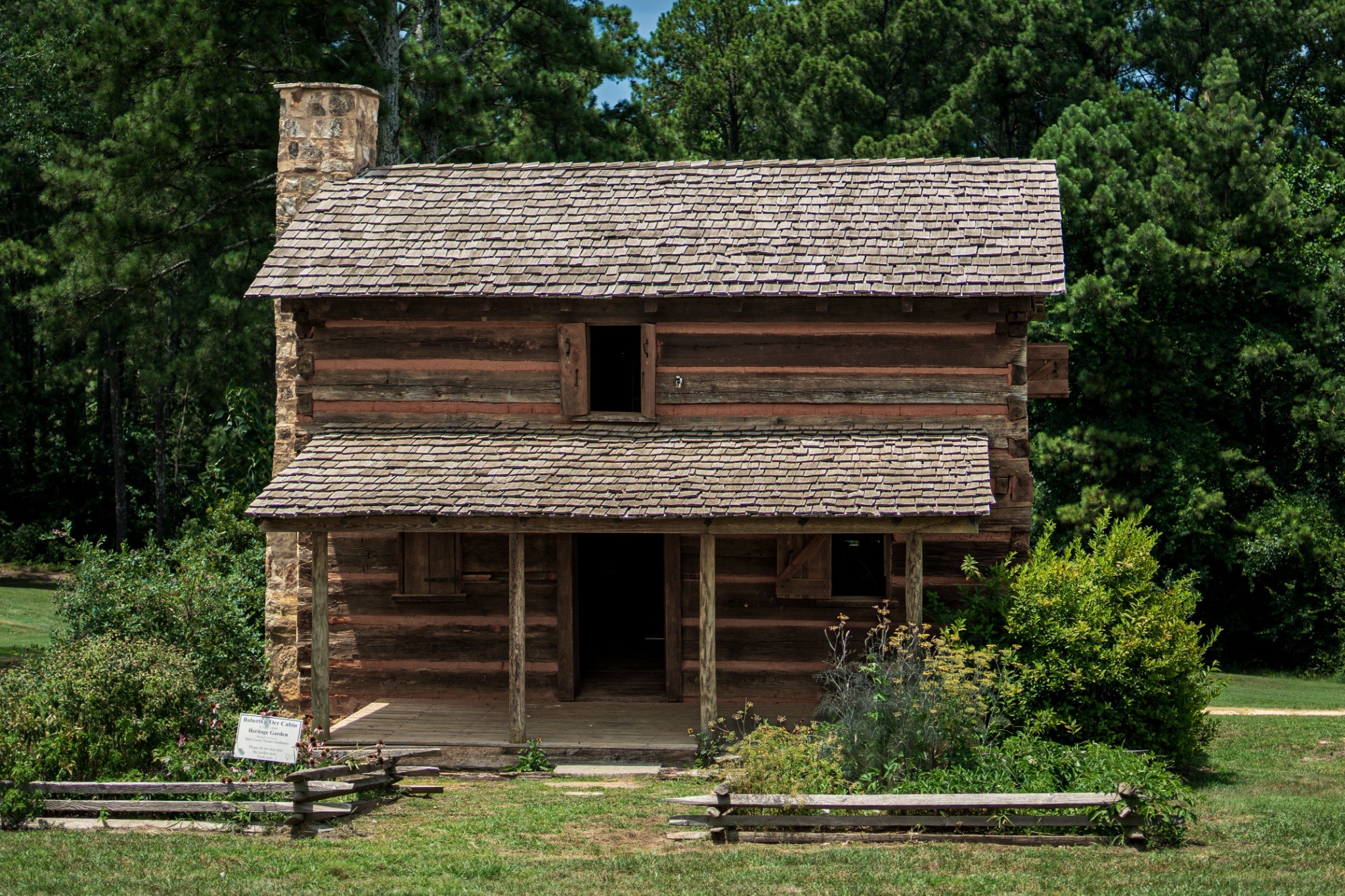 Historic wooden cabin among trees — photography by Andrew Frady