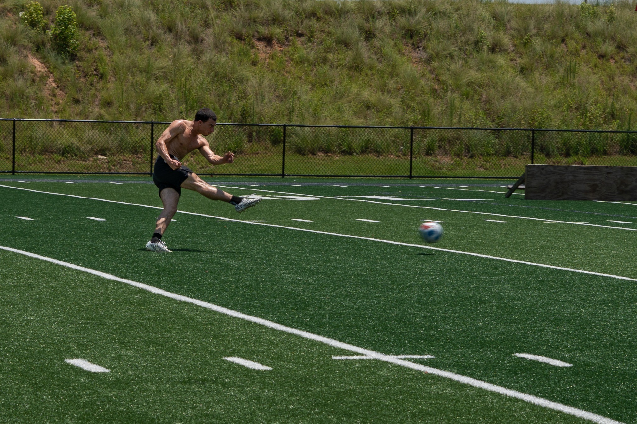 Soccer player following through on a kick — photography by Andrew Frady