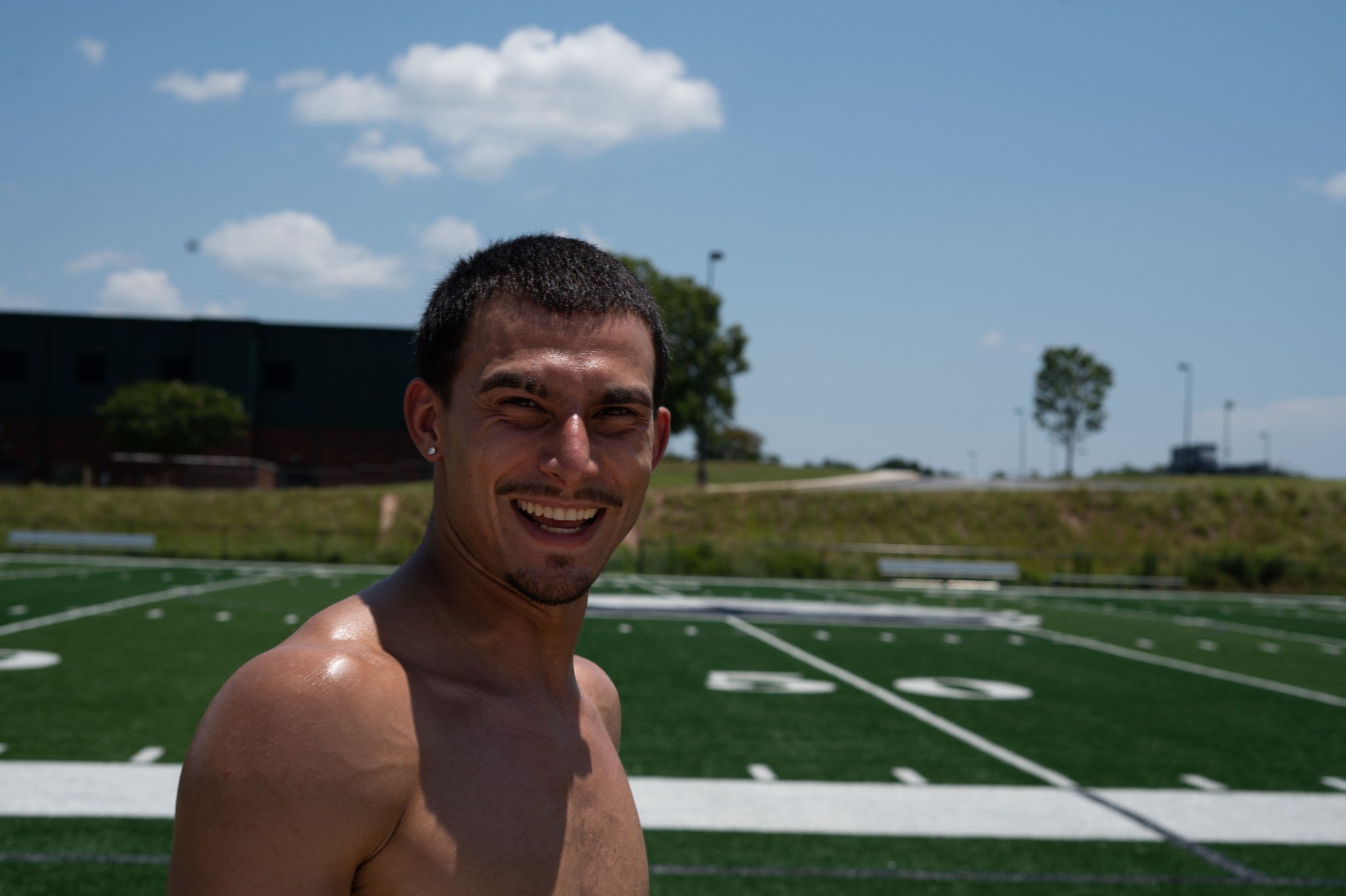 Smiling athlete on the field — photography by Andrew Frady