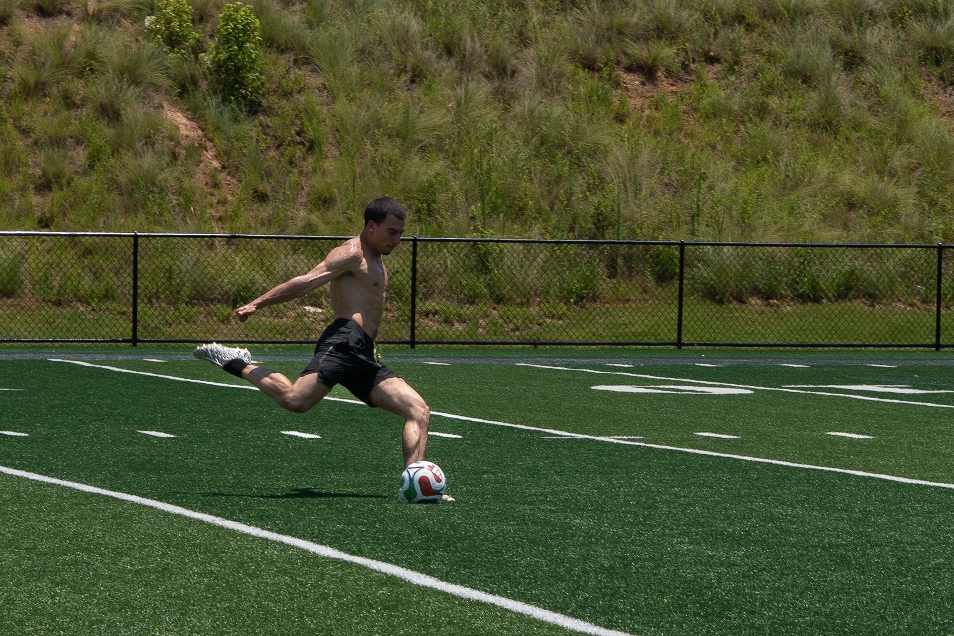 Soccer player striking the ball — photography by Andrew Frady