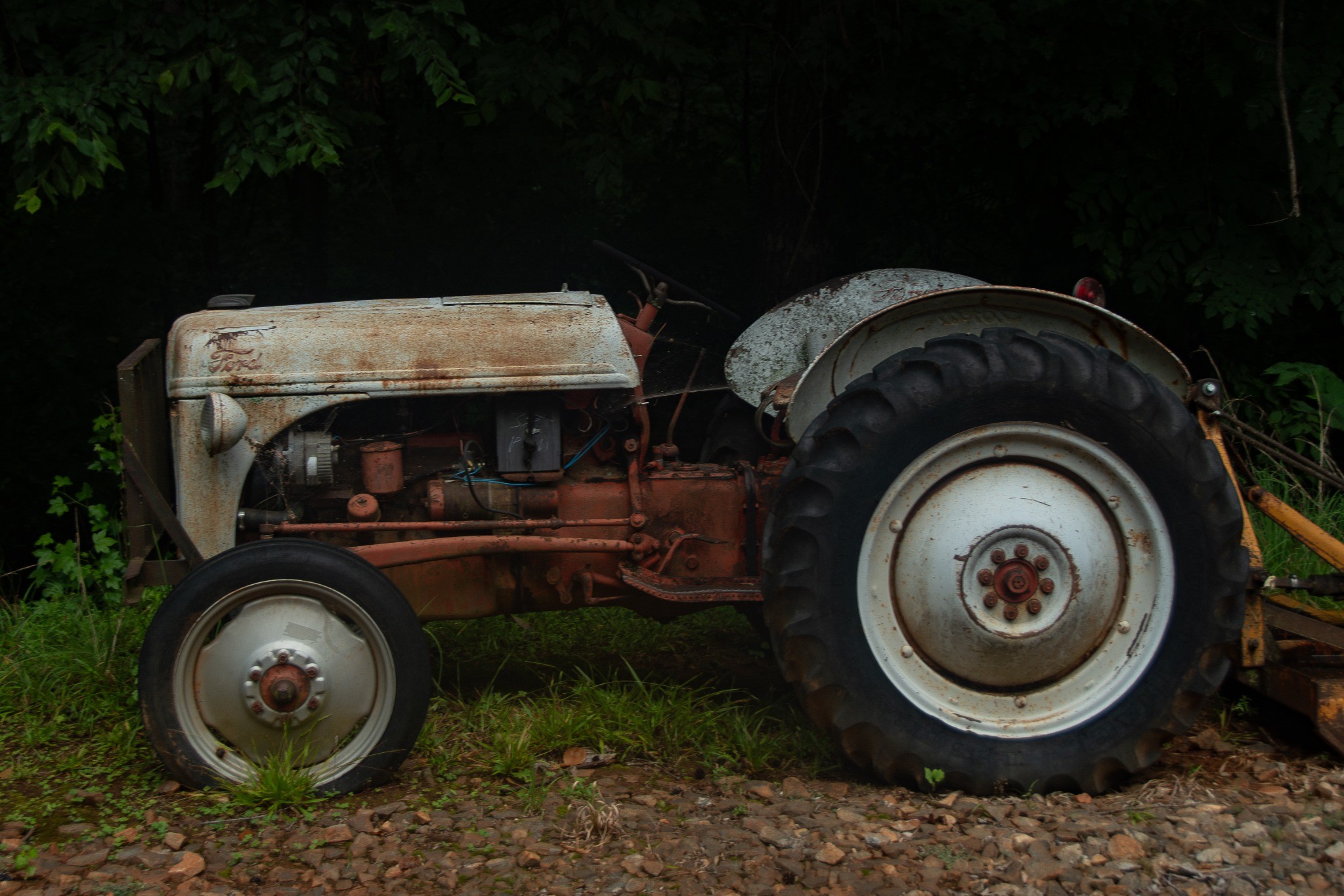Weathered tractor at the edge of the woods — photography by Andrew Frady