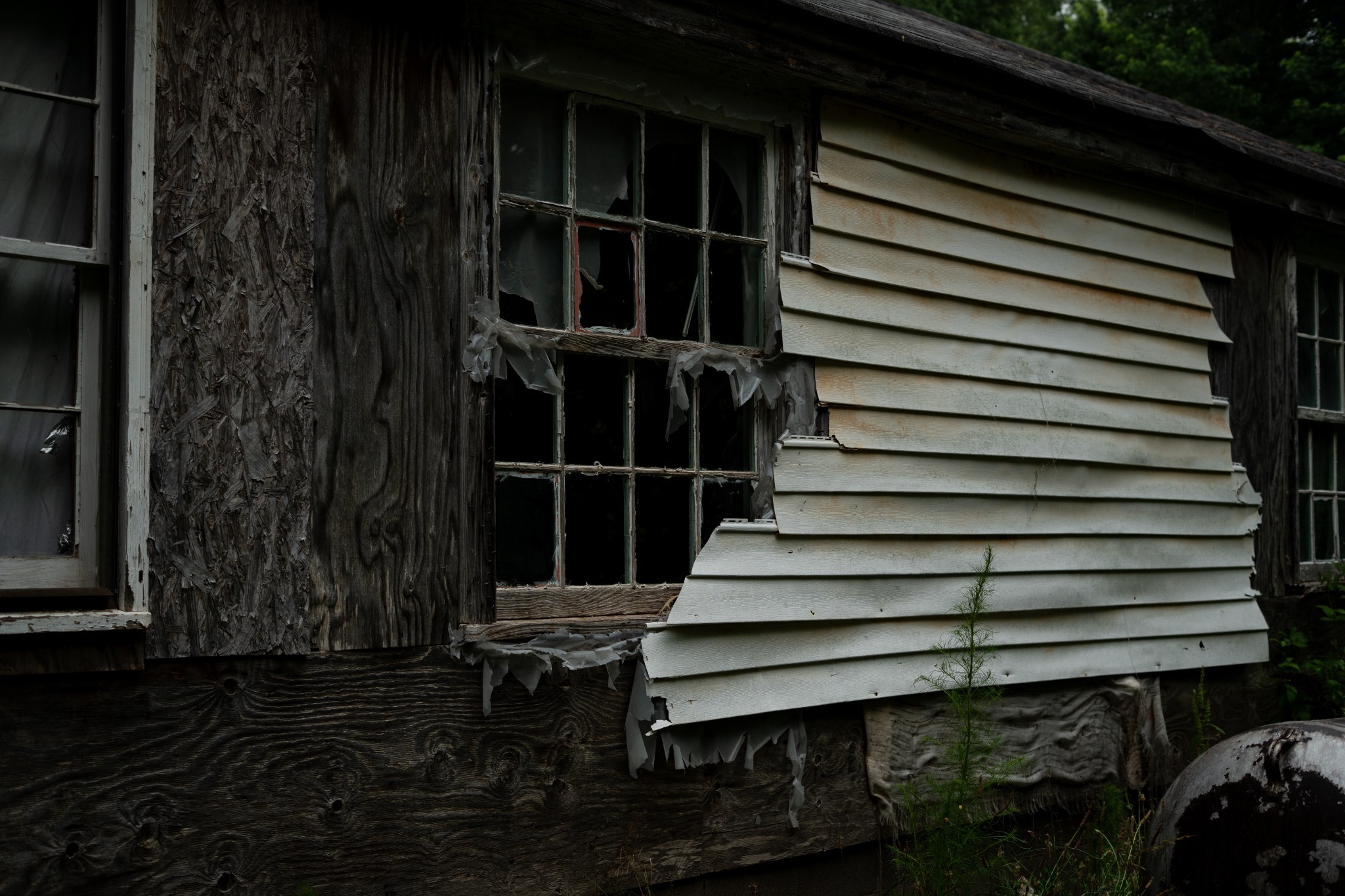 Weathered house with broken windows — photography by Andrew Frady
